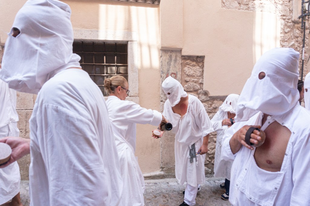 Assistants pouring wine on spugni of battenti during Riti Settennali in Guardia Sanframondi - 2024